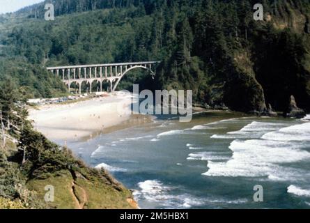 Pacific Coast Scenic Byway - Oregon - Cape Creek Bridge. Die Cape Creek Bridge, ein weiteres Meisterwerk der Technik von McCullough, liegt hoch über dem Devil's Elbow State Park, einem der vielen Strandzugänge in Lane County, südlich von Cape Perpetua. Direkt neben diesem Gebäude befindet sich der historische Leuchtturm Heceta Head. Standort: Oregon (44,133° N 124,122° W) Stockfoto