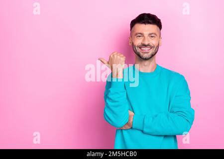 Foto des selbstbewussten Promoters junger Student Mann, der Inhaber eines Unternehmens empfiehlt, einen leeren Bereich mit direktem Finger auf pinkfarbigem Hintergrund anzubieten Stockfoto
