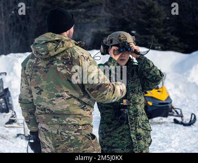 EIN US-AMERIKANISCHER Der Soldat der Armee-Spezialeinheit zeigt der Republik Korea-Spezialeinheit Soldier Cpt die Ausrüstung für seine Kampfhelme vor. Yeo Ukjin im Joint Pacific Multinational Readiness Center 22-02 in der Nähe von Ft. Greely, AK, 18. März 2022. Die US-Streitkräfte und die alliierten Streitkräfte wandeln sich in Koordination um, um Amerika zu verteidigen und gemeinsame nationale Sicherheitsinteressen zu schützen. Stockfoto