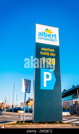 Trebic, Tschechische Republik - 28. Dezember 2022: Handelsschild des ALBERT Store vor blauem Himmel mit dem Text "Täglich geöffnet". ALBERT ist der größte Supermarkt Stockfoto