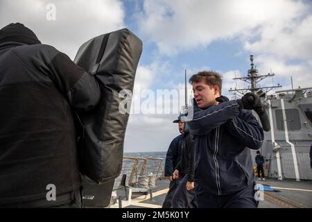 NORWEGISCHE SEE (21. März 2022) Retail Service Specialist Seaman Ghavan Wilson schlägt während eines Sicherheitsreaktionskurses für Oleoresin-Capsicum-Spray (OC) an Bord des Arleigh-Burke-Class-Guided-Missile Destroyer USS Roosevelt (DDG 80) am 21. März 2022 eine Matte. Roosevelt, nach Rota, Spanien, stationiert, ist auf seiner dritten Patrouille in den USA Sechster Einsatzbereich der Flotte zur Unterstützung regionaler Verbündeter und Partner sowie nationaler Sicherheitsinteressen der USA in Europa und Afrika. Stockfoto