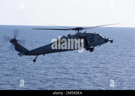 Ein MH-60s Nighthawk, der an die „Tridents“ des Helicopter Sea Combat Squadron (HSC) 9 angehängt ist, nähert sich während des Flugbetriebs der USS Gerald R. Ford (CVN 78), 21. März 2022. Ford führt im Atlantik im Rahmen der auf das Schiff zugeschnittenen Grundphase vor dem Einsatz die Zertifizierung des Cockpits und die Qualifikation von Luftfahrtunternehmen durch. Stockfoto