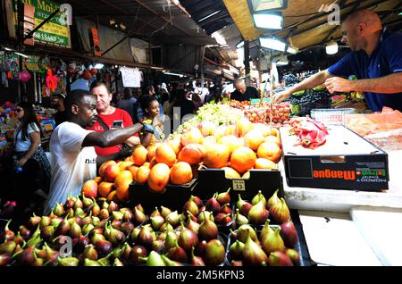 Ein Obstverkäufer auf dem lebhaften Carmel-Markt in Tel-Aviv, Israel. Stockfoto