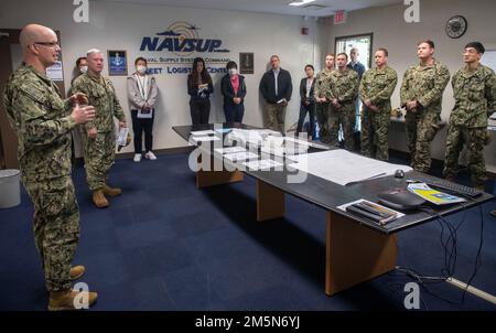 Hinterer ADM. Carl Lahti, Commander, Navy Region Japan/Commander, USA Naval Forces Japan spricht mit Seeleuten und Mitarbeitern des Naval Supply Systems Command (NAVSUP) Fleet Logistics Center (FLC) Yokosuka Site Sasebo während einer Führung durch die Treibstoffanlagen des Kommandos am 29. März 2022 bei Commander, Fleet Activities Sasebo (CFAS). Lahti besuchte die NAVSUP FLC Yokosuka Site Sasebo Tankstellen und traf sich im Rahmen eines geplanten Besuchs bei CFAS mit den Führern der Sasebo City, Saikai City und der japanischen Maritime Self-Defense Force, um sich mit der Anlage und der Umgebung vertraut zu machen. Stockfoto