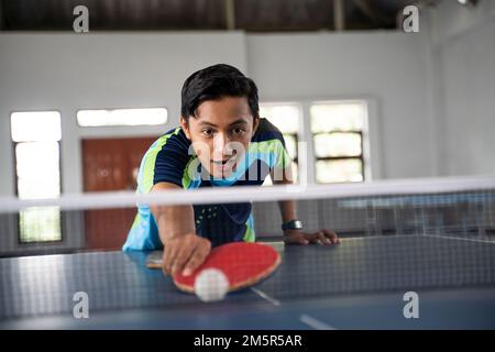Der männliche Tischtennisspieler bekommt den Ball nicht Stockfoto