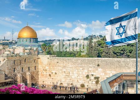 Eine israelische Flagge weht, während jüdische orthodoxe Gläubige die Torah lesen und vor der Westmauer beten, auch bekannt als Klagemauer in der Altstadt von Jerusalem Stockfoto