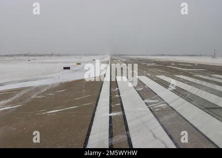 Die Start- und Landebahn in Wind und Schnee am Flughafen Cleveland Hopkins am 24 2022. Dezember nach Schneesturm. Stockfoto