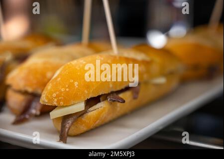 Typischer Mini-Burger-Snack aus dem Baskenland, Pinchos oder Pinxtos, kleines Stück Brot mit verschiedenen Belägen, serviert in der Bar in San-Sebastian oder Bilba Stockfoto