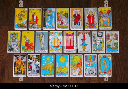 Die 22 großen Arcana-Karten eines Tarotdecks auf einem Holzhintergrund liegen über dem Kopf Stockfoto