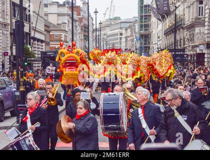 London, Großbritannien. 1. Januar 2023 Die Teilnehmer treten mit einem chinesischen Drachen auf der Londoner Neujahrsparade in Piccadilly auf. LNYDP ist eine jährliche Parade durch die Straßen des Londoner West End. Kredit: Vuk Valcic/Alamy Live News Stockfoto