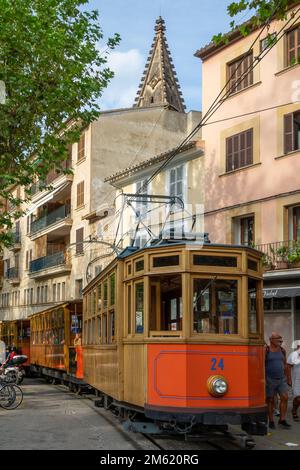 Soller, Spanien; 27. August 2022: Beliebter Soller-Zug auf Mallorca (Spanien), der durch das Stadtzentrum voller Menschen, Restaurants und Denkmäler fährt Stockfoto