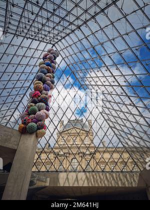 Unter der Glaspyramide des Louvre, vertikaler Hintergrund. Wunderschöne architektonische Details mit einer abstrakten Mischung aus klassischem und modernem Stil Stockfoto