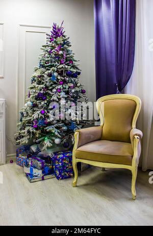 Ein dekorierter Weihnachtsbaum steht im Wohnzimmer. Stockfoto
