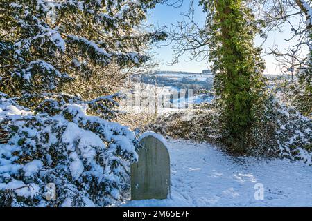 Die Quelle des Flusses Frome im frühen Winter auf den Cotswolds vom Friedhof in Brimpsfield, Gloucestershire, England, aus gesehen Stockfoto