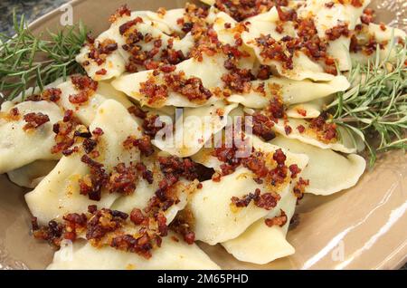 Müllkippen, serviert auf dem Teller, garniert mit frischem Rosmarin. Stockfoto