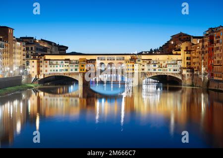 Florenz, Italien an der Brücke Ponte Vecchio, die in der Dämmerung den Arno überquert. Stockfoto