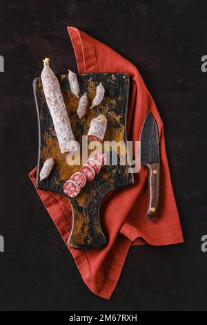 Draufsicht auf fermentierte Salami-Würste mit weißem Schimmel auf Holzbrett Stockfoto