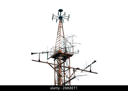 Alte Antenne im Nebel vor dem Hintergrund von Häusern, isoliert auf weißem Hintergrund. Die Fernsehantenne für den Empfang von Radio-TV-Signalen. Stockfoto