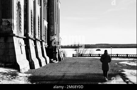 Ein Schwarzweißbild des Mannes von hinten, der in der Nähe des Schlosses spaziert Stockfoto