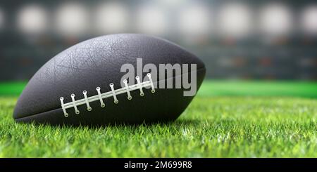 American Football Ball auf einem üppigen grünen Wiesenfeld Stockfoto