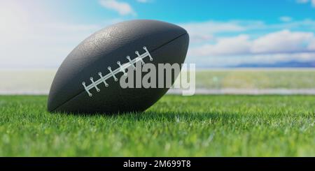 American Football Ball auf einem üppigen grünen Wiesenfeld Stockfoto