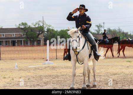 Sergeant Vincent Aquino, ein Mechaniker auf Rädern, der mit dem 4. Infanterie-Division Fort Carson am Color Guard arbeitet, und Sergeant Major Tank, sein Pferd, salutieren der Jury während des regionalen Kavalleriewettbewerbs am 21. April 2022 im Fort Concho National Historic Landmark, San Angelo, Texas. Die Reiter nahmen an Militär- und Kampfreiten, Pistolen- und Säbelreiten Teil. Stockfoto