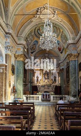 Eze, France - August 1, 2022: Main nave and presbytery of Our Lady Assumption church, Notre Dame de l’Assomption in historic old town of Eze Stock Photo