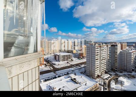 Eiszapfen hängen auf dem Balkon des Hauses Stockfoto