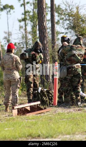 Readiness Challenge VIII Teilnehmer verschiedener Einheiten der Air National Guard kämpfen mit der ersten Station auf dem Hinderniskurs -- indem sie Missionsschutzausrüstung anlegen -- am letzten Morgen des Wettbewerbs am 22. April 2022 auf dem Silver Flag Übungsgelände, Tyndall Air Force Base, Florida. Die Veranstaltung der Abteilung der Luftwaffe CE wird vom Air Force Civil Engineer Center ausgerichtet. Nach mehr als 20 Jahren Pause ist die Challenge, eine der wichtigsten Veranstaltungen für DAF-Bauingenieure, wieder da. Die diesjährige Readiness Challenge ist das erste Event zur Betriebsfähigkeit, bevor die Herausforderung voll wird Stockfoto