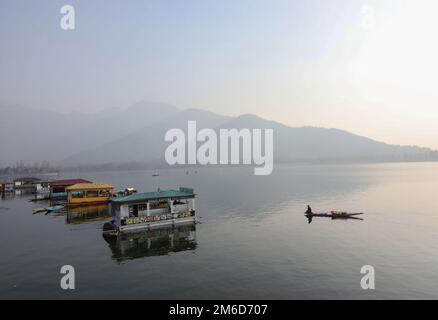 Srinagar, Indien. 02. Januar 2023. An einem kalten Wintertag in Srinagar rudert ein Bootsmann mit seinem Boot über den Dal-See. Kredit: SOPA Images Limited/Alamy Live News Stockfoto