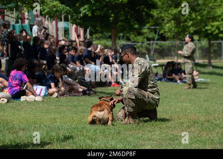 USA Air Force Senior Airman Joshua Thompson, 23. Sicherheitstrupp-Geschwader, arbeitender Hundeführer, Haustier Timo, ein MWD, während einer K-9 Demonstration in St. John, die Evangelistische katholische Schule, Valdosta, Georgia, 25. April 2022. Um den Monat des Militärkindes hervorzuheben, den St. John Faculty veranstaltete die K-9-Demo, um die Wertschätzung für die Militärstudenten und ihre Klassenkameraden zu zeigen. Militärische Arbeitshunde trainieren für bestimmte Aufgaben, einschließlich Aufspüren von Sprengstoffen, Suche und Rettung. Stockfoto