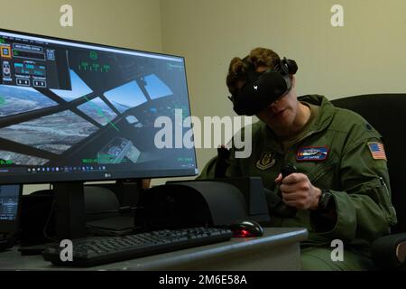 LT. Oberstleutnant Jay Capper, 731. Airlift Squadron Pilot, übernimmt die Steuerung eines Virtual-Reality-Simulators während der jährlichen Schulung zum modularen bordseitigen Feuerlöschsystem in Gowen Field, Idaho, 26. April 2022. Die Maschine wurde entwickelt, um die Bedingungen wiederherzustellen, die Piloten bei der Brandbekämpfung aus der Luft erleben, wenn sie zur Bekämpfung von Waldbränden aufgerufen werden. (USA Air Force Tech. Sgt. Justin Norton) Stockfoto