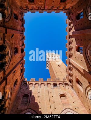 Torre del Mangia und Palazzo Comunale in Piazza del Campo - Klarer blauer Himmel - Siena, Toskana, Italien Stockfoto