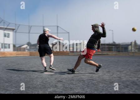 USA Die Mitarbeiter der Küstenwache auf der Basis Kodiak spielen am 27. April 2022 Kickball während einer Moralveranstaltung, die vom Hauptquartier der Basis Kodiak in Kodiak, Alaska, ausgerichtet wurde. Ziel der Chiefs war es, an einem sonnigen Tag Personal aus verschiedenen Einheiten auf der Basis zusammenzubringen. USA Foto der Küstenwache von Petty Officer 3. Klasse Janessa-Reyanna Warschkow Stockfoto