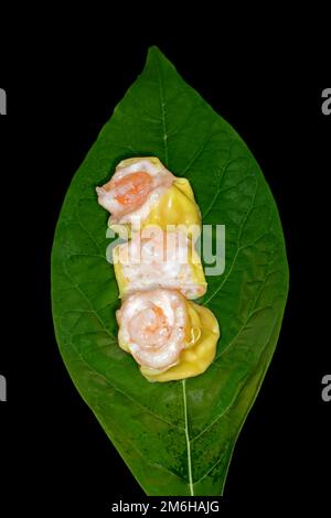 Dim Sum mit Fischfarce und Garnelen, Essensfotografie mit schwarzem Hintergrund Stockfoto