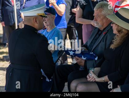 Mr. Derek Black, Right, Private Waldean Black's engster Verwandter wird während der Beerdigung von Private Waldean Black in Perryton, Texas, am 28. April 2022 mit der amerikanischen Flagge von LT. Oberstleutnant Rogelio Salvador Oregon, Executive Officer der Marine Artillery Detachment Oklahoma, Left, präsentiert. Private Black war während des Angriffs auf Pearl Harbor an Bord der USS Oklahoma und wurde in einem Massengrab nicht identifiziert, bis jüngste DNA-Tests seine Identität bestätigten und er nach Hause zu seiner Familie in Perryton, Texas, gebracht wurde. Stockfoto