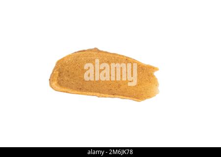 Abstriche von köstlicher Erdnussbutter auf weißem Hintergrund. Isoliertes Bild Stockfoto