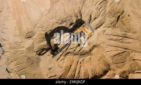Draufsicht des auf der Baustelle arbeitenden Baggers. Stockfoto