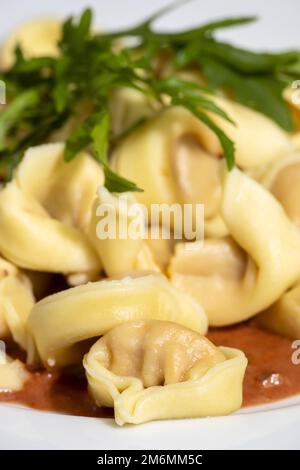 Tortellini-Pasta auf einem weißen Teller Stockfoto