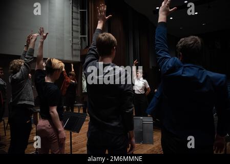 LA CROSSE, Wisc. (2. Mai 2022) der Musiker der 1. Klasse Amy Broadbent aus Rockville, Maryland, führt die Schüler während einer Bildungsklinik an der Viterbo Univeristy durch Dehnungsübungen. Der Chor der United States Navy Band Sea Chanters trat während seiner 13-Städte-Tour, 2.000 Meilen, in sieben Staaten auf und verbindete Gemeinden im ganzen Land mit ihrer Navy. Stockfoto