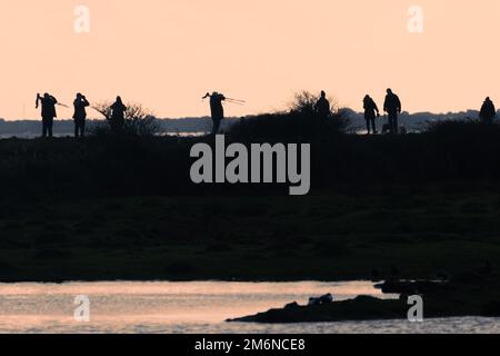 Vogelbeobachter im Farlington Marshes Nature Reserve, Hampshire, England, Großbritannien. Gesunde Outdoor-Aktivitäten oder Hobby. Stockfoto