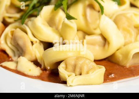 Tortellini-Pasta auf einem weißen Teller Stockfoto