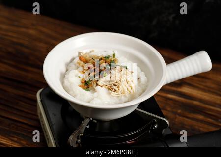 Nahaufnahme Chinesisches Claypot Chicken Porridge oder Bubur Bakar oder Panggang, asiatisches Frühstück. Stockfoto