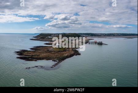 Blick auf die Landzunge Mumbles mit dem historischen Leuchtturm und den Piers in Swansea Bay Stockfoto