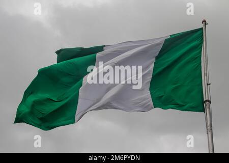 Nigerianische Flagge, mit drei vertikalen Streifen in Grün, Weiß, Grün. Die beiden grünen Streifen stehen für natürlichen Reichtum, und die weißen für Frieden und Unten Stockfoto