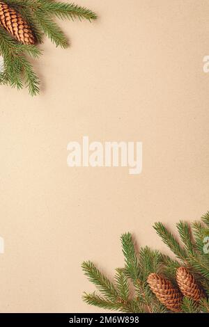 Christbaumzweige auf braunem Papierhintergrund, Fichtenzweige und Zapfen flach legen, Kopierraum Stockfoto