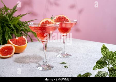 Sommerliche erfrischende Cocktails mit Grapefruit. Limonade mit frischem Rosmarin garniert. Sommergetränk mit Sekt Stockfoto