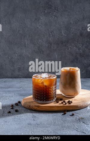 Espresso Tonic, kaltes Getränk mit Espresso und Tonic im Glas. Eiskaffee in einem großen Glas mit Sahne und Kaffeebohnen. Stockfoto