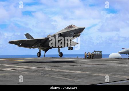 PHILIPPINISCHE SEE (8. Mai 2022) ein F-35C Lightning II, der den "Black Knights" of Marine Fighter Attack Squadron (VMFA) 314 zugewiesen wurde, bereitet sich auf eine verhaftete Landung auf dem Flugdeck des Nimitz-Klasse-Flugzeugträgers USS Abraham Lincoln (CVN 72) vor, während das Schiff im philippinischen Meer unterwegs ist. Solche Möglichkeiten für Angriffe auf die Seefahrt ermöglichen es der US-Marine, weit über die typischen organischen Sensorfunktionen im Indo-Pazifik hinaus zu finden, zu reparieren und anzuvisieren. Diese Fähigkeit dient unter anderem als Abschreckung für aggressive oder böswillige Akteure und unterstützt einen freien und offenen Indo-Pazifik Stockfoto