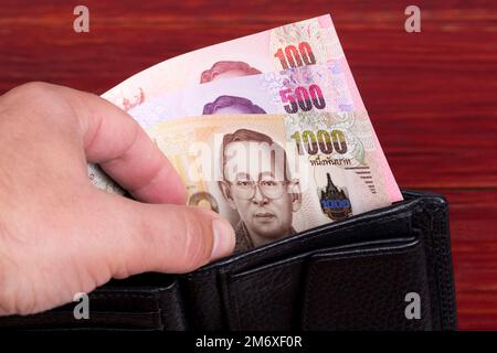 Thai Money - Baht in der schwarzen Brieftasche Stockfoto